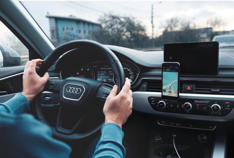 man-driving-audi-a4-using-navigation-app